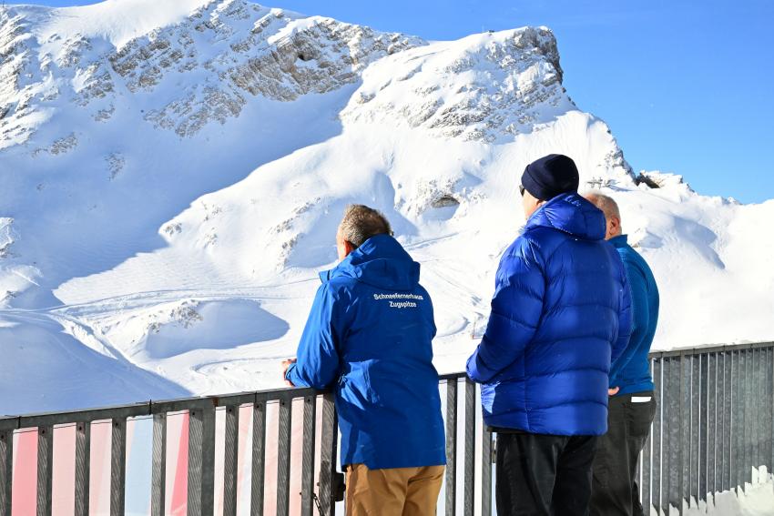 von hinten: Am Geländer stehen von links nach rechts: Umweltminister Thorsten Glauber, Ministerpräsident Dr. Markus Söder und Peter Marton (Geschäftsführer Betriebsgesellschaft UFS), sie schauen auf den Schneefernergletscher.