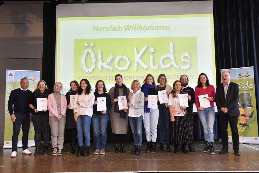 Gruppenfoto zeigt Umweltminister Thorsten Glauber (Foto links), die Vertreterinnen und Vertreter der ausgezeichneten Kindertageseinrichtungen und Dr. Norbert Schäffer, 1. Vorsitzender LBV (Foto rechts).